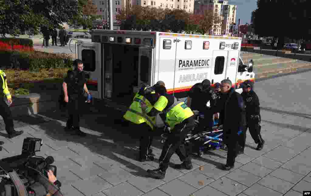 Police and paramedics transport a wounded Canadian soldier in Ottawa, Canada.