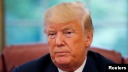 U.S. President Donald Trump listens to a question during an interview with Reuters in the Oval Office of the White House in Washington, Aug. 20, 2018. 