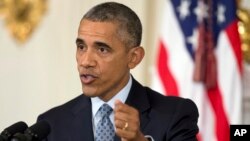 President Barack Obama speaks to reporters in the State Dining Room of the White House in Washington, Oct. 2, 2015.