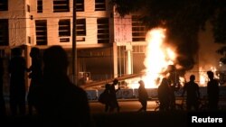 George Floyd protesters set Minneapolis police station afire