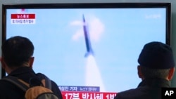 People watch TV reporting North Korea's missile test at Seoul Railway Station in Seoul, South Korea, Tuesday, March 4, 2014.